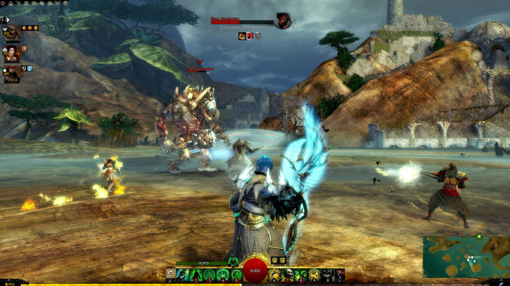 Guild Wars 2 is considered one of the best free RPG games and allows for exciting battles, as the screenshot illustrates: The player is seen from behind in third-person centered in the lower half of the screen, fighting a giant, spiky beast standing in the background together with other characters. The female character on the left is performing yellow, star-like spells, while the male character on the right is firing a rifle at the enemy. The character himself appears to be shooting at the beast with a blue enchanted bow. The ground is brown and muddy and some green-brown mountains can be seen in the background.