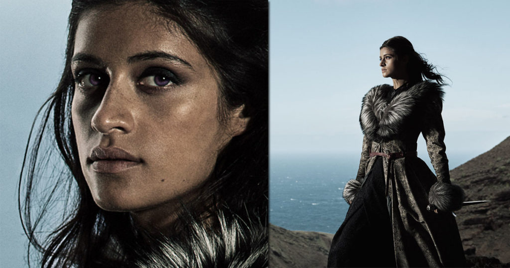 In this picture, you can see Anya Chalotra in the role of Yennefer von Vengerberg. She will also be part of the cast of The Witcher Season 3. We see her on the left half of the picture in close-up, looking at us with a tempting gaze. In the right half of the image, she stands in a semi-total profile on a rock facing her left, holding a dagger in her left hand. Here again, she wears her black fur coat. In the background, we see the sea.