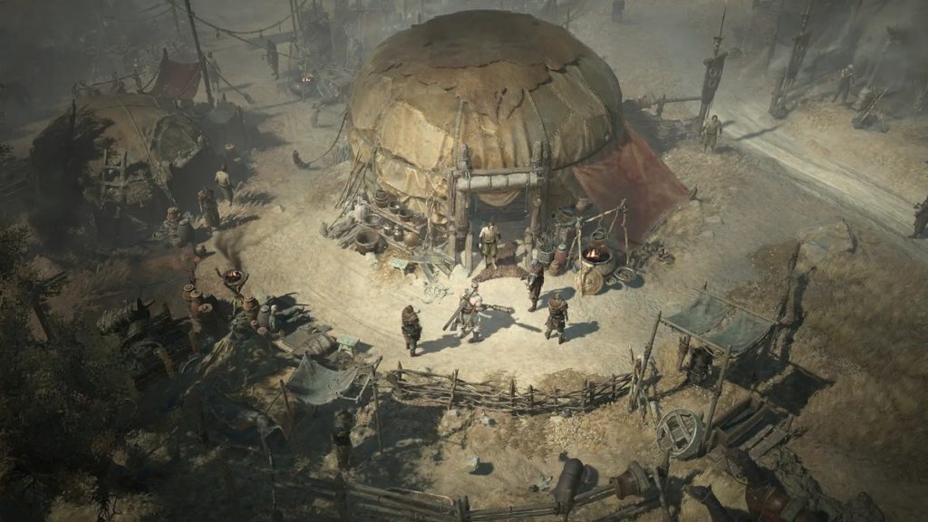 A big Diablo 4 leak reveals never-before-seen in-game footage. In this image we can see an example of a screenshot from the new part, officially released by Blizzard. It shows a dusty camp in the middle of the so-called Dry Steppe by daylight, revealing an oriental character. In the center of the image is a round, tent-like building, in front of which the character is standing along with four other NPCs. Around the building, wooden fences, tent-like canopies, and metallic and wooden objects are shown in a circular arrangement.