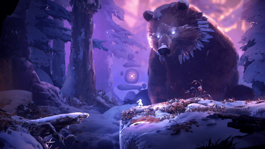 The fact that platformer games have very nice graphics is shown by the jump 'n' run "Ori and the Will of the Wisps". Here we see a screenshot from the side-scrolling 2.5D game, in which the main character is a small white forest spirit standing in the middle of the picture in front of a huge bear, which rears up in the background with white glowing eyes. The scene is very much in purple tones. The landscape and also the ground of the character are covered with snow. In the background, there are a lot of huge tree trunks and fir trees, which are also covered with snow. In the distance, the red evening light shines through the branches and also reaches the protagonist.
