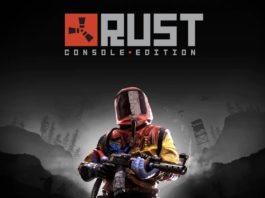 In this picture, we can see the cover of the game Rust, which can be considered one of the best survival games for PS4 and PS5. The cover shows a game character in a red and yellow combat outfit including a full helmet in the lower half of the picture, holding a rifle in his hand and looking at the viewer. He stands in front of a black-and-white background, in which the landscape and parts of buildings can be seen. Above the figure is the logo and the title of the game "Rust" in gray capital letters.