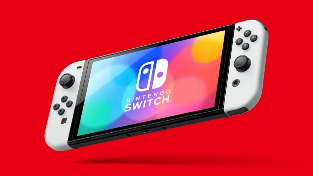 Many Nintendo rumors are circulating around the Switch 2. In this picture, we can see the Nintendo Switch (OLED model) in total view from the front in a slightly perspective view floating in front of a red background. It has white Joy-Cons here and many different colored blurred circles are shown overlaid on the reflective display. Above it is the logo with the title 