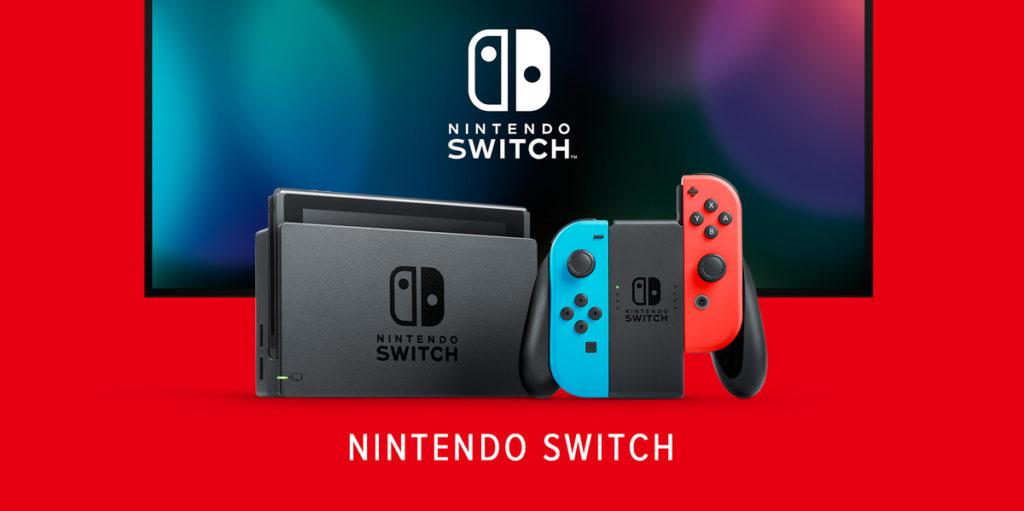 The Nintendo Switch can be seen centrally in the docking station in total view against a red background. Behind the console, slightly raised and in a slight crop, is a large LCD screen with the Nintendo logo in white. On the screen behind the logo is a dark background with several overlapping colorful blurred circles. Immediately to the right of the docking station is a Switch controller seen in total view consisting of two Joy-Cons. The left Joy-Con has a turquoise color, which is already plugged in. The right one has a red color and is about to be plugged in. Underneath, it says "Nintendo Switch" in white capital letters. It remains to be seen whether the Switch 2 will also look like this.