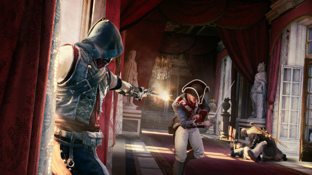 Stealth games like Assassin's Creed Unity, for example, offer a very special gaming experience in a breathtaking setting in Paris. In this screenshot, we see the protagonist in the blue hood in the front left of the image in a long shot profile. He is currently standing in front of a high window in a majestic hall that runs from the foreground to the background, made of a red carpet and draped with red fabric. He looks at a guardsman with a saber approaching in the hall and shoots him with a pistol. Behind the shot soldier lies another one on the floor, over which another assassin is just bent. 