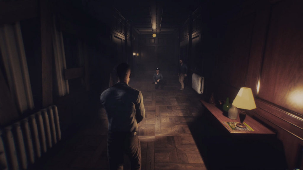 In this screenshot, we see a character in the third person view with a flashlight in a narrow, dark wooden corridor, which runs from the front straight into the background of the image. On the left side we can see a barricaded window and below it a heater. On the right side we see a wooden chest of drawers in the lower right corner of the picture, on which there is a copper-colored table lamp with a yellow lampshade and bottles of different colors. In the middle ground of the picture we see two characters in the glow of the flashlight. The left person kneels, the right person stands. Both are dressed in blue and look towards the player. The corridor disappears into the darkness in the background. Warm colored lights are reflected on the ceiling. Multiplayer horror games like Dead Frontier are also extremely entertaining for horror fans.