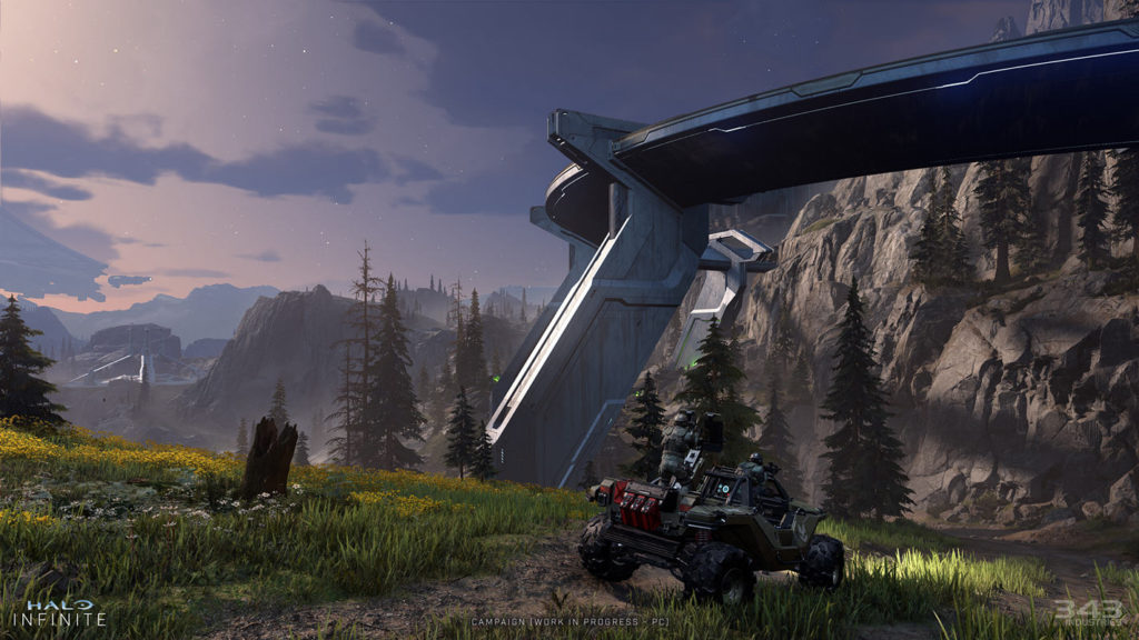 We see a buggy patrol at dusk, in front of a futuristic High Bridge. In the background of this screenshot from Halo are some mountains and the sky is bathed in beautiful purple and light orange with a few scattered clouds.
