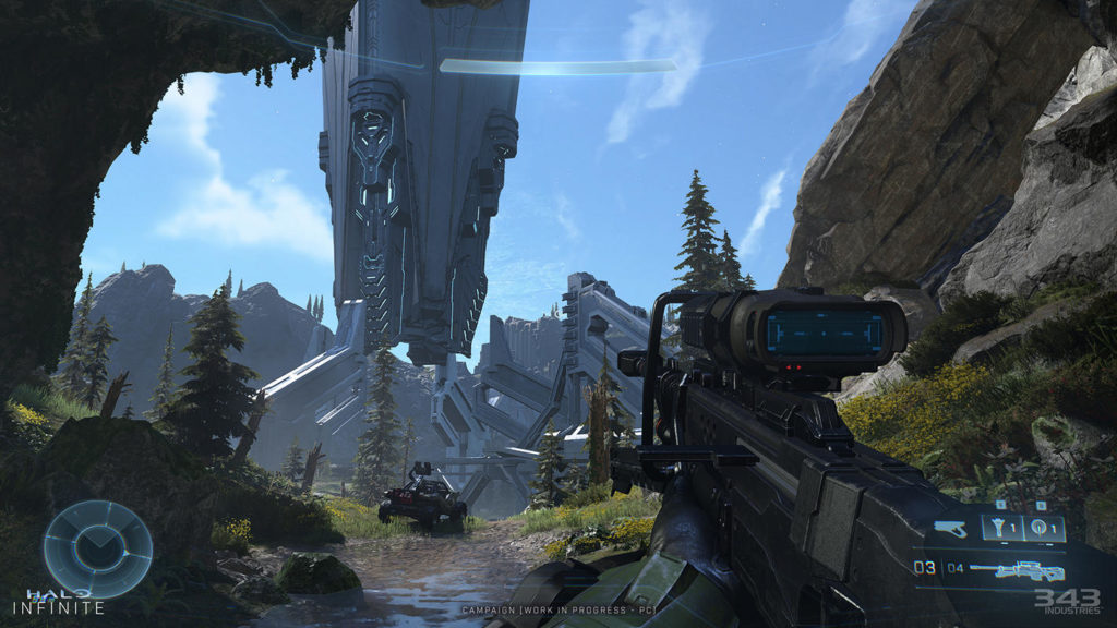 A screenshot of the game from the first-person perspective, showing a futuristic weapon and the player interface in the foreground. We are standing under a rock, and in the distance we can see a large tower made of modern materials. In front of it is a buggy. A great screenshot and another reason to look forward to the upcoming Halo Infinite update.