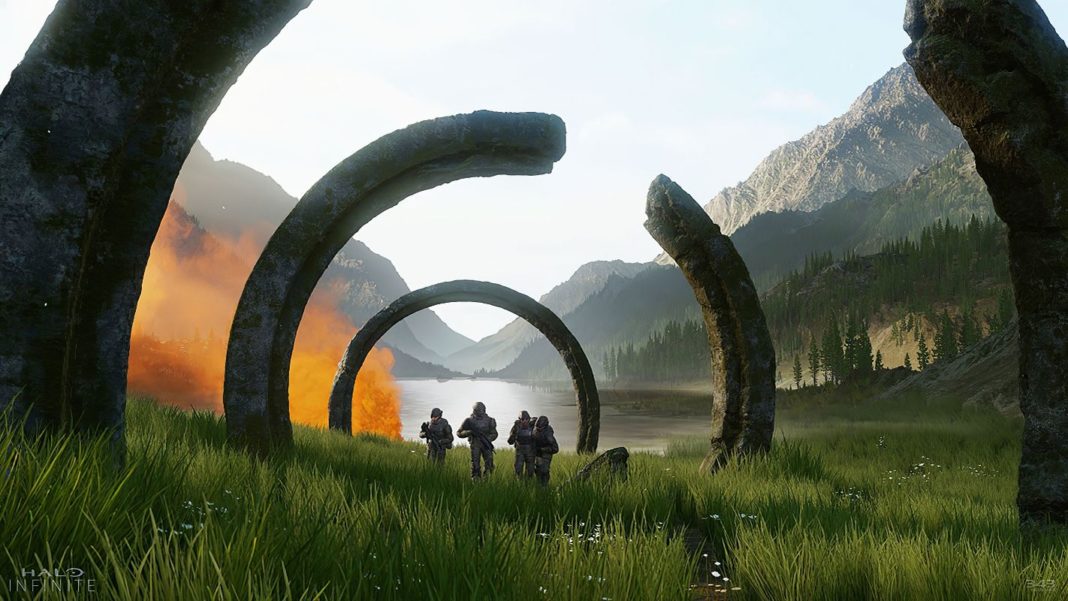 Players can look forward to the upcoming Halo Infinite update, illustrated here with an image of Spartans running towards the viewer under broken, round and stone arches. In the background, orange smoke can be seen in front of a lake framed by mountains and lush Nordic nature.