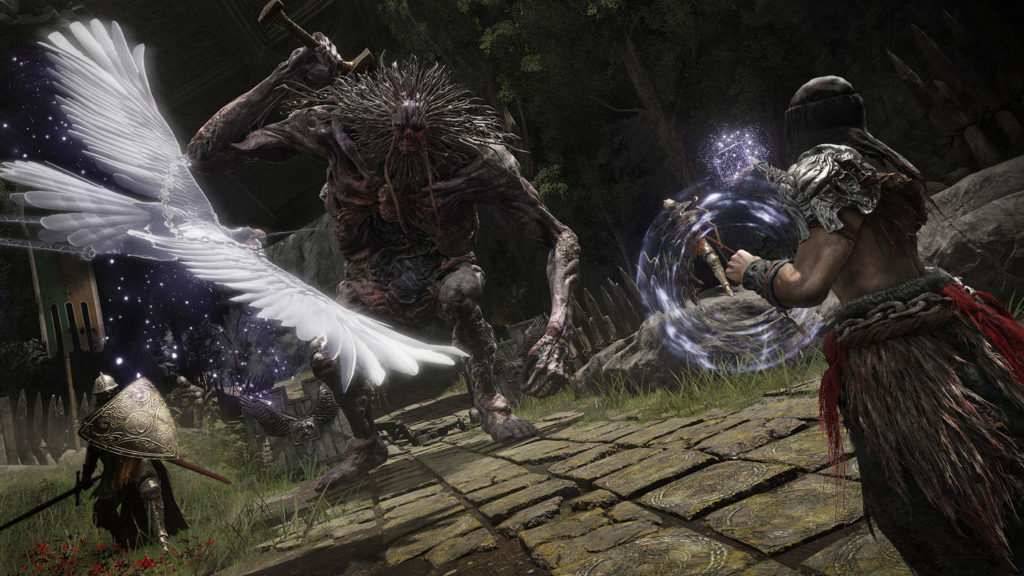 In the action RPG Elden Ring, you can play one of the best PS5 co-op games together with friends. In this screenshot, you can see a character in the third person view in a tilted perspective at the right edge of the game in the foreground. He is wearing fur-like pants, silver shoulder pieces as well as a black cap. He is currently performing a spell skill, causing purple glitter to spill out of his left hand. His gaze falls on a huge nightmarish demonic figure with a head from which numerous spikes extend and a mace in his right hand. The scene takes place in a stone corridor under the open sky at night. At the bottom left of the picture stands a knight with a shield and a sword in his hand. In the upper left foreground, we glimpse a white bird with outstretched wings, also trailing purple glitter.