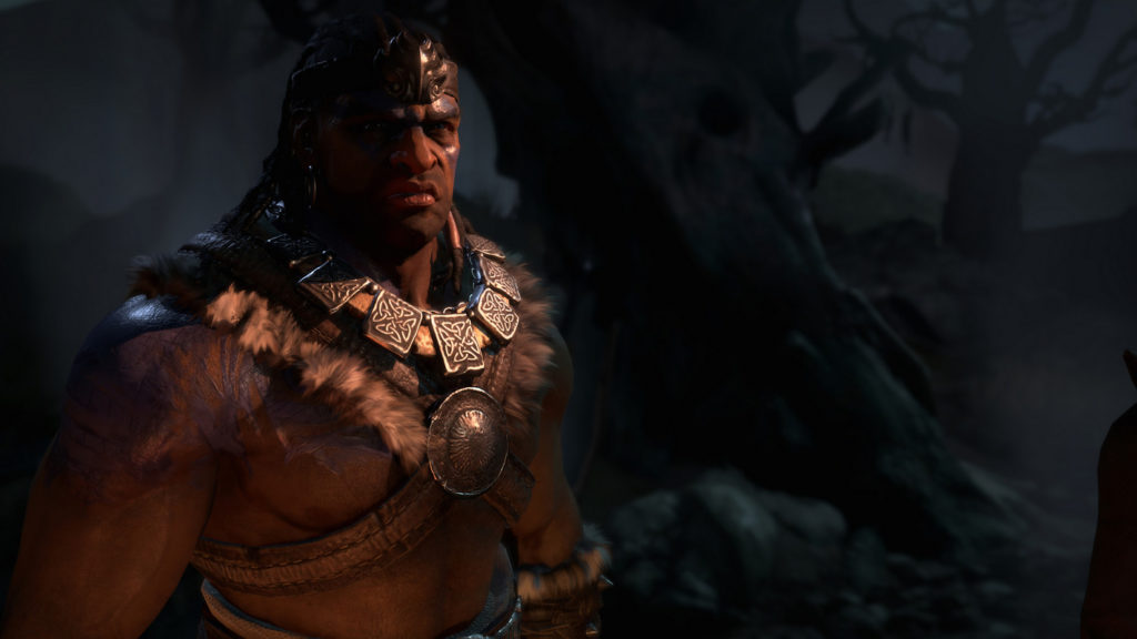 In this screenshot, we see the barbarian in the semi-close-up on the right as one of the five possible classes in Diablo IV. He is shown at night in front of a very dark blurry forest and illuminated with warm light coming from the front. He stands topless with a large wide iron chain around his neck in semi-profile with his arms outstretched, looking grimly past us on the right. We can expect a Diablo 4 release date as early as April next year.