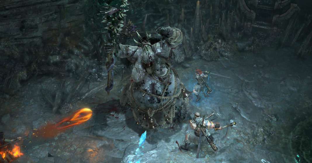 Play with familiar classes in Diablo IV and fight impressive boss battles, as seen in this screenshot: We look down on the action from above in an isometric perspective. In a dark, cold stalactite cave, there is a huge slimy pale creature in the center of the image. It holds a large spiky club in its right hand and looks straight up at the cave ceiling. To its right, two players stand around the creature, shown in total view. The player in the upper right is a female character with long red hair, armor, and a sword with which she is about to strike. Further down, the other player stands as a muscular barbarian who is also striking at the beast with two axes. From the left, a fireball and an icicle fly at the creature in the middle. A Diablo 4 release date is already possible in April 2023.