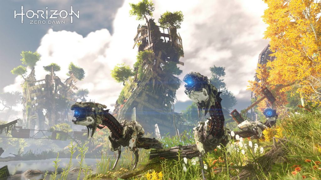 Hunt robot animals in a post-apocalyptic world covered with plants, as seen here in the screenshot: In the foreground, three robotic predator-like creatures are shown in a blooming landscape during the day in a long shot. They look in our direction and a blue light shines from their mouths. On the right is a yellow-leafed tree and in the background we see wooden barracks towering in the mist, which are covered by plants and trees. In the background is the blue sky with numerous white clouds.
