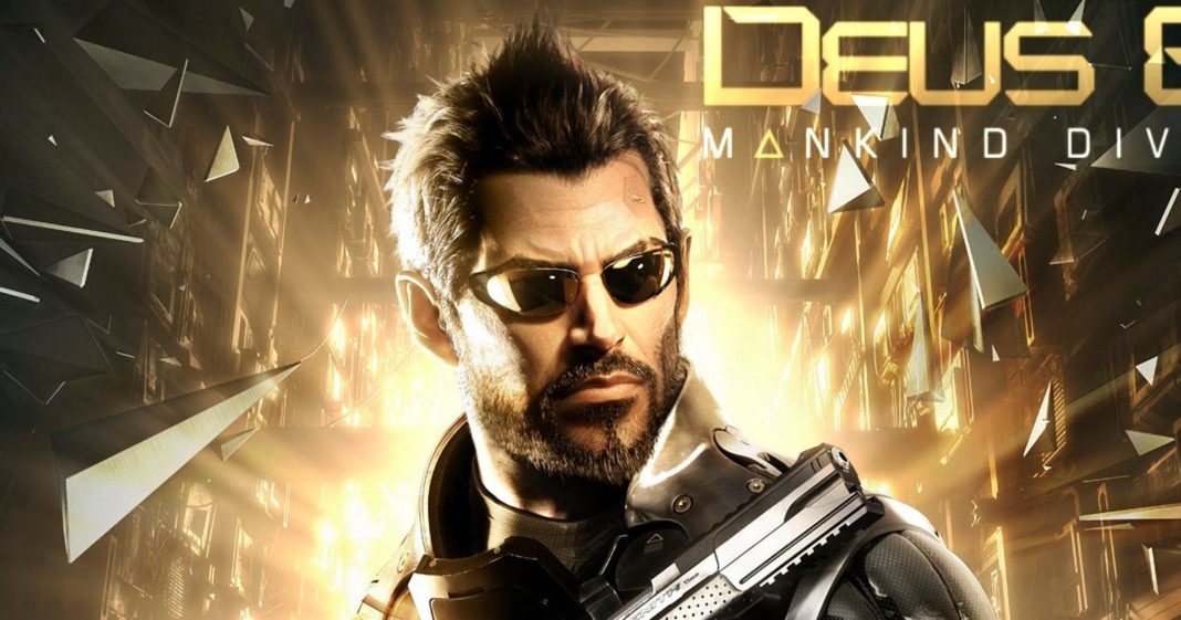 Here we can see a cover of the game Deus Ex: Mankind Divided, where you can see the main character. Eidos is apparently working on a new Deus Ex game. The protagonist is shown from the front in a close-up with short black hair and black sports glasses in a black combat suit. He wears a short beard cut into shape and holds a pistol upwards, which we can see in the crop at the bottom of the image. Behind him, a huge glass building is visible. A violent explosion is taking place in it so that numerous glass fragments fly through the air and illuminate the background of the picture with a strong yellow light so that a bright light outline is created around the head of the protagonist.