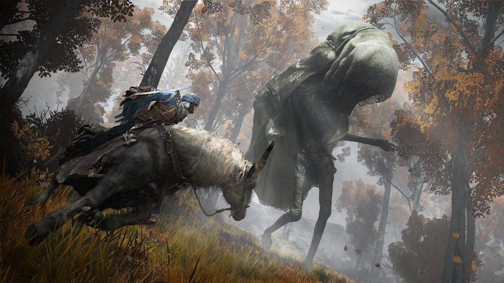 In Elden Ring, you fight against very nasty enemies, as this screenshot proves. We look in a tilted perspective at a sunlit clearing in a forest with tall trunks and golden-brown leaves. In the front left of the image, the player can be seen in a long shot on a gray horse with a white mane in the foreground. He is doing a 180-degree turn with his horse and we see him and the steed in profile. He is wearing a blue shirt, leather armor, and a blue iron helmet. In his right hand, he holds a sword ready for battle. His gaze falls on a huge nightmarish black figure with skinny legs, thin arms, and an oversized head covered by a dark green cloth robe that reaches to his feet. The creature seems to turn straight to his right. The new title from FromSoftware is one of the most popular open world games on PC.