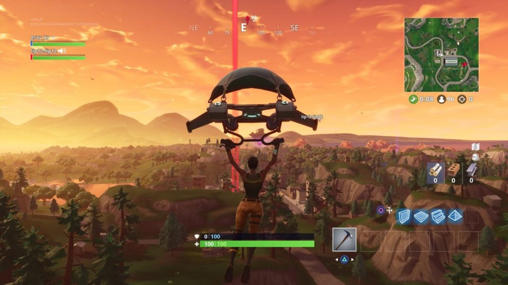 In this screenshot from Fortnite, we see the player as a female character in the third person in the wide shot at the bottom center of the image. He is hanging from a futuristic parachute and glides straight down to a very green landscape, in which numerous hills with many fir trees can be seen. In front of him in the center of the image, there is also a red beam reaching up into the sky from the ground, representing a marker. Games like Fortnite are very popular among 2 player PS5 games on the PlayStation and Xbox. The character has short black hair, and wears a dark green top and beige combat pants. The scenery is bathed in an orange-red light from the setting evening sun, which we see very strongly in the background in particular, and also colors the sky very strongly orange. A minimap is shown at the top right and a weapon and item display for the player is shown below it. At the bottom of the screen in the middle is a health and shield bar.