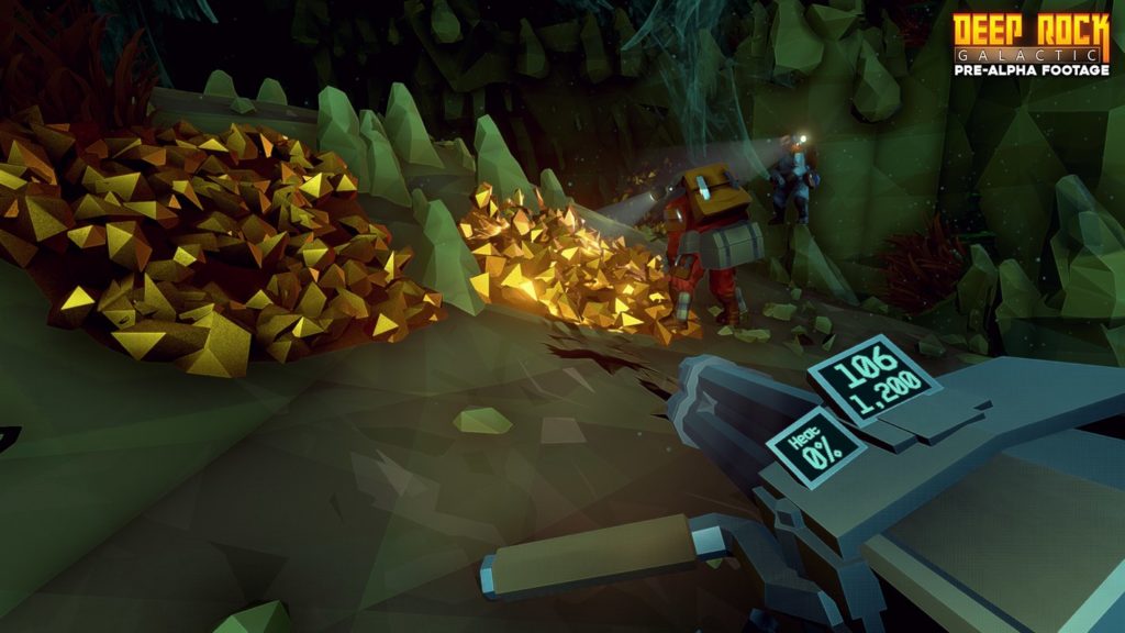 In Deep Rock Galactic you search for valuable resources in procedurally generated cave systems in one of the best PS5 co-op games, as seen here in this screenshot: As a player in the role of a dwarf, we are looking in first-person perspective at a mineral field consisting of numerous golden sparkling polygons, which we can see a bit further in the background of the image in the upper left corner. We are holding a minigun in our hands, which has a digital ammunition and temperature gauge attached to it, which is shown in the lower right of the image. The game basically looks very polygon-like graphically. To the right of the field in the background are another red player and a blue player dwarfs. Both are shining their flashlights on the mineral field, since the cave is otherwise very dark and consists of many dark green stones.