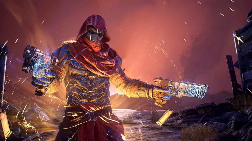 Co-op PS5 games like Outriders are very reminiscent of Borderlands, as this screenshot illustrates. On the left side of the screen, a character is shown in half-total, looking at us. He is wearing a shimmering blue metallic futuristic armor with a large red hood pulled over his head. His face is covered by an equally futuristic and blue reflecting metal mask and we only see two blue shimmering eyes. Also reflecting blue are the two heavily decorated metal pistols he holds in his hands. We are in a post-apocalyptic environment. Around the player we see wooden boards and scrap metal lying around. The sky is illuminated in red and directly behind the player there is a glistening bright light, which illuminates the environment and the character from behind.