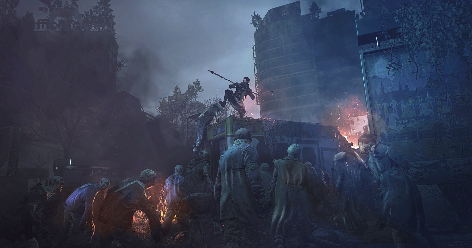 In this screenshot from Dying Light 2: Stay Human, we see the player in the center of the screen, armed with a spear, in a long shot in a gloomy post-apocalyptic city. He is standing on an abandoned ambulance overgrown with plants and is kicking down a zombie that is climbing up. The entire image is shrouded in smoke and we can make out isolated buildings in the clouds of smoke. In the background, a skyscraper is on fire. In the foreground, numerous zombies stand around the ambulance, trying to reach the player. This title is one of the best scary games to play with friends and one of the most sought-after co-op horror games today.