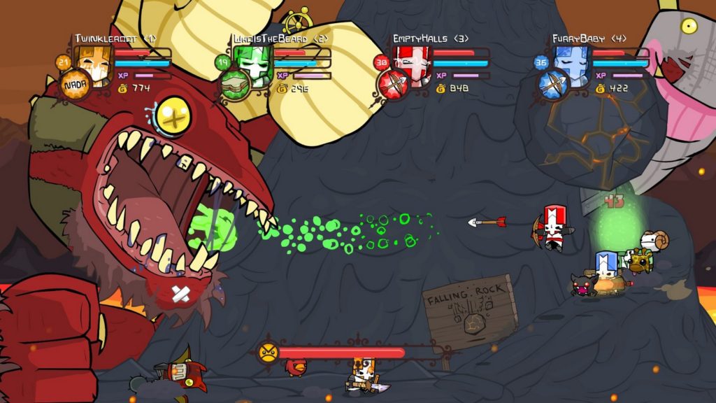 The 2D sidescroller Castle Crashers is a fun cooperative beat 'em-up adventure. In this screenshot, four players are currently in a boss fight. We catch a glimpse of the players from the side on the right of the image in a long shot in front of a kind of dark gray volcano, which can be seen in the background in the crop. On the left side of the image is a huge red creature, which consists of a single giant head with yellow eyes and a wide open mouth with pointed counters. In the lower-left corner, a large fist of the creature can be seen. At the top of the image, four-player indicators are shown in a row, consisting of the avatar image, a life bar, a mana bar, as well as a gold indicator. The players all have different childlike appearances and possess different coloring. Two of the players strongly resemble a knight.