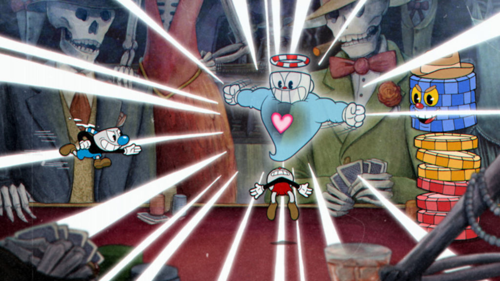 We look at a screenshot from the game Cuphead. We can see a cartoon-like hand-drawn colorful 2D game world where the two main characters in the role of Cup heads fight against a floating ghost. The battle arena consists of a red poker table where skeletons with different clothing sit, which we glimpse in the background and foreground in the crop. They have cards in their bony hands, smoke cigars and there are poker chips on the table. On the right side of the picture, an opponent is depicted in the form of a colorful stack of chips, scowling and smiling at the players. In the center of the image is a light blue floating ghost, with arms outstretched and the same cup-shaped head as the players. He is performing a powerful attack, so that white lightning bolts radiate from him and run out of the picture. As he does so, he pulls one of the players towards him, who is below him. He has a white head, a black torso, and red shorts. The player on the left looks very similar, except he has a blue round nose and blue shorts. The game characters are much more color-saturated and powerfully drawn, which makes them stand out well against the game world.
