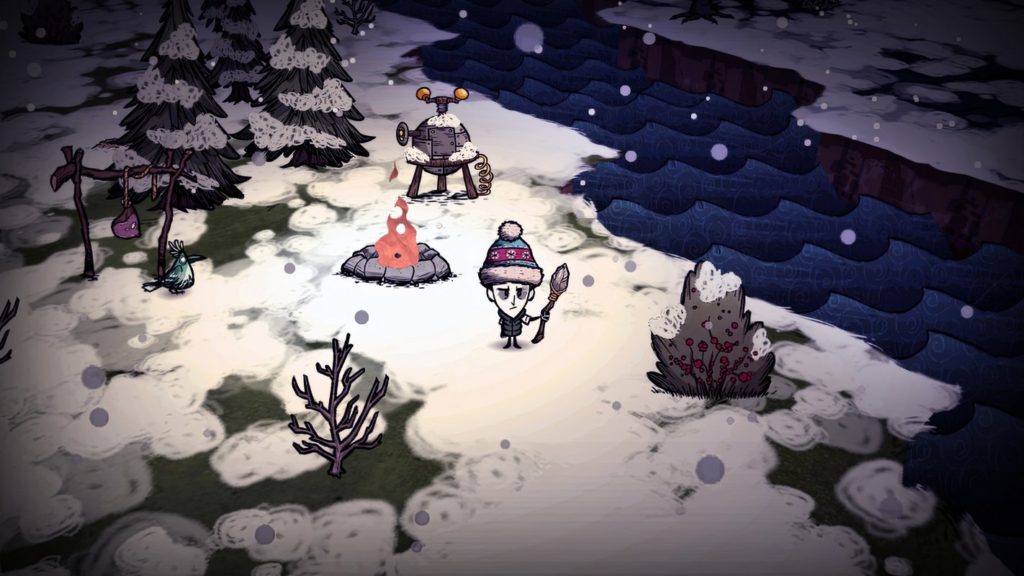 The player is seen here in hand-drawn 2D graphics in the long shot in isometric perspective centrally in the picture. He stands in a heavily snow-covered, dreary snowy landscape and looks in our direction with tired eyes. His head is oversized and he has a white skin color. On his head, he wears a light blue magenta colored bobble hat and in his left hand, he holds a self-made spear with a stone tip. Diagonally left above him blazes a campfire and above it is a kind of metal cauldron. To the left of the campfire, a wooden contraption can be seen with a piece of meat hanging from it. A green bird sits next to this wooden apparatus and looks to the right of the picture, a blue river runs diagonally from the upper center to the lower right of the picture.