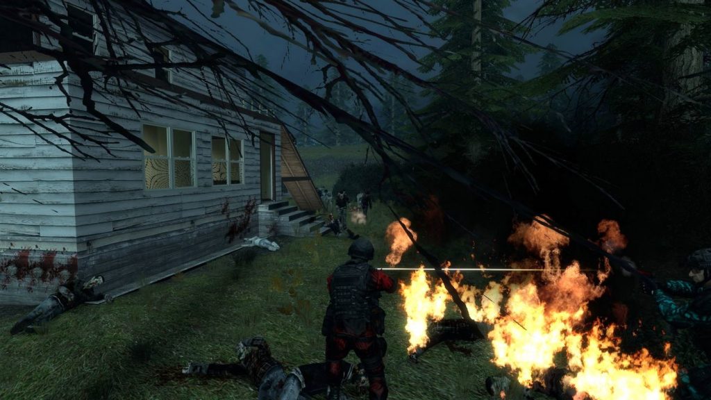 This screenshot shows that this free-to-play title is extremely tactical: We see our playable character in the third person at the bottom center of the image. He is wearing a red combat suit with a black bulletproof vest and a black helmet. In the lower right corner, a squad member in a green camouflage uniform and black helmet can be seen too. Both players open fire on approaching zombies, which are shown in the background in the center of the image. The players are in a forest section at night. Dark fir trees can be seen on the right and in the foreground of the image, and on the left side of the image is a large multi-story wooden house with several windows, in which light is burning and an open door. The ground right by the players is burning and flames can be seen. The sky is dark blue and a green hill with more fir trees can be seen in the background. In multiplayer horror games like Codename Cure, teamwork and collaboration are required to survive.