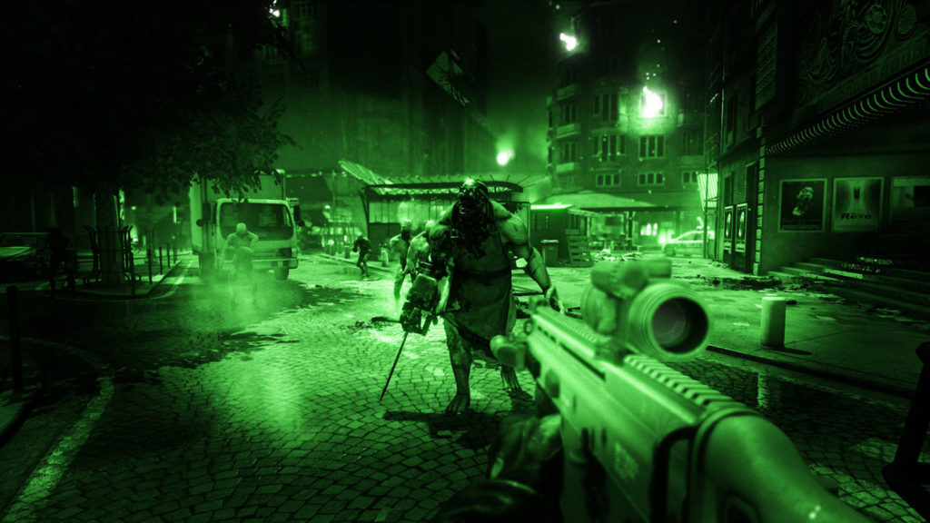 The player stands in first-person perspective at the edge of a marketplace on a street. He holds a machine gun with a scope in his hands, which he points at a muscular monster with a wide-open mouth and a bald head. The creature holds a chainsaw in its right hand and is facing the player. It stands in front of the player and is shown in a long shot in the center of the frame. Through the player's night vision device, we glimpse several wooden booths with various canopies in the square behind the creature. To the left of the image is a white truck around which three other smaller creatures can be seen running straight toward the player. Around the marketplace are several apartments, from which flames are coming out of some windows on the right of the picture. At the top left of the image is a tree with a lot of dense leaves.