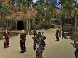 This screenshot shows the player in a third-person mode in the wide shot at the bottom center of the screen. He wears a brown leather-like armor with very rigid shoulder pieces. On his back, he carries a very long iron sword. He stands in the daytime in a medieval village in a palm landscape with sandy soil. At the back left a wooden hut with a thatched roof is depicted. Directly in front of him are four characters standing around looking at each other. On the right, wooden objects such as barrels can be seen and brown rocks rise in the background. At the bottom left, we again see a plain red health bar, but this time much smaller in the corner. At the top of the image, we can see the blue sky with scattered clouds. Gothic 1+2 for Nintendo Switch will probably be released in 2023.