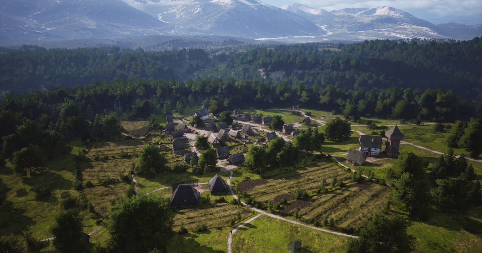 In this screenshot from Manor Lords, we look down from the air at a medieval settlement in the daytime, which is located in the center of the image in the distance in a clearing. The houses all have a gray-brown tone and thatched roofs, and together with the paths are placed very organically and realistically. Around the settlement, there are some very realistic-looking fields and numerous green trees stand around the town. Behind the settlement, a huge stretch of forest extends deep into the background, where we can see a mighty horizontally running mountain range with snowy peaks at the top of the image.