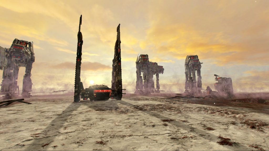 This screenshot of Lego Star Wars: The Skywalker Saga shows several AT-ATs in the background walking on a dusty desert ground. The setting sun can be seen in the background. The four-legged giant robots, which look like large predators, are shown in the image in a horizontal slightly staggered arrangement, moving slowly in our direction. In the image, they are shown in a long shot in the vertical center of the image. On the left side of the picture, a bit more in the foreground, a black command shuttle is shown with two large vertically raised wings and a red glowing cockpit. Play with this title perhaps one of the best PS5 split screen games in the Lego universe.