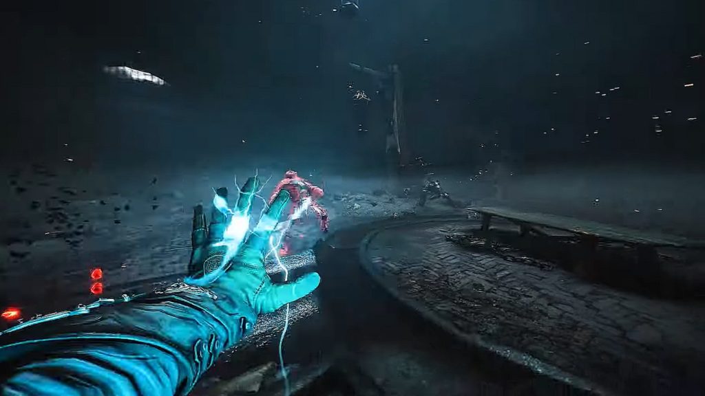 Here is a screenshot from Witchfire. The game was first announced by NVIDIA today. We find ourselves as a player in the first-person perspective in a very gloomy urban environment during the night. With our left hand, we are executing a blue lightning attack on a red creature standing in front of us, so that it falls to the ground. To the right of us is a circular platform, on which an elongated wooden table stands. At the top left of the image we see a white light source and at the left edge of the image there are blood splatters, which come from an enemy that has just been killed by us. The frame has numerous bright particles flying through the air.