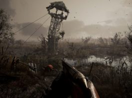 In Stalker 2 you can run through a huge post-apocalyptic open world. We also get to see this in a gameplay trailer. Here is a screenshot of it. In this one, we look from the player's point of view in first person view at a vast, gray, gloomy swampland that consists of many ponds and stagnant bushes. The player is holding a shotgun, which we see at the bottom center of the image. Right in front of him, a mutated creature is walking around on the swamp floor. It has a reddish skin color and resembles a large arachnid with several legs. To the right and left of the image are black dead trees in a crop. In the background, a tower scaffold rises from the swamp, bent to the right by the destruction and looking very damaged. The sky is light gray and overcast and we see many flying particles in the air.