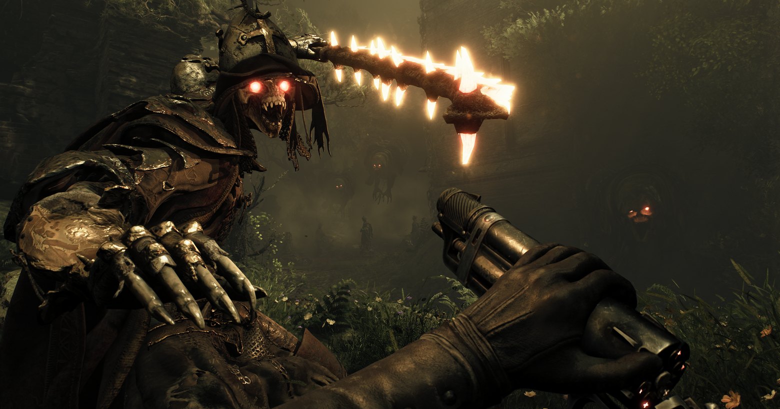 Here we see a screenshot from the new shooter Witchfire. We are the player in first-person perspective in a very dark interior courtyard, which is overgrown with numerous green plants. Just now we are reloading a futuristic-looking revolver, which we can see in the lower right corner of the image. On the left side, there is a skeletal witch-like creature with a brown robe, red glowing eyes, and a leathery hat. The creature is about to strike a blow with a burning club. In the background, we can see the outlines of tall stone buildings and in the center of the background, there are two flying demonic creatures with red glowing eyes. This shooter contains very fast-paced gameplay and is a roguelite title.