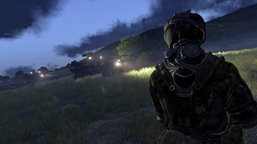 Build your own campaign in one of the best sandbox games on Steam, as illustrated here in this screenshot of Arma 4: The player can be seen in the third-person view on the right of the image in the semi-close-up. He is on a grassy landscape at night and has a green camouflage combat suit on including a helmet. The player is approaching a green military vehicle, which we can see in the background in the profile on the left. Its bright headlights cast a cone of light to the right, illuminating large parts of the grass on the right side of the screen. In the distance to the left, we can see another vehicle of this type with its headlights also activated. In the background, a hilly landscape stretches horizontally and above it, we see a night sky with dark blue clouds.