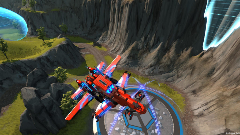 In the long shot, we see a crafted flying red robot in the form of a space shuttle at the bottom center of the image. It is facing us and is flying away from a round gray-blue platform on the ground. It is daytime and to the right of the platform are steep gray rocks jutting out of the image and extending into the background. There is also a brown road leading from the platform into the background. On the left side of the picture, we see rocky plateaus covered with grass. At the top left and top right of the screenshot, we can see turquoise shield-like shapes.