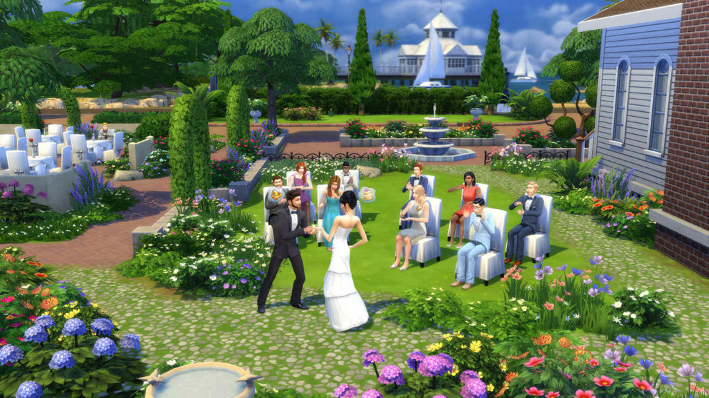 Take part in the simulated life of your Sims, as shown in this screenshot: We catch sight of a bride by daylight in a manicured garden with lots of colorful plants. They can be seen in the center of the image and are currently dancing between bushes in front of applauding seated guests, who are sitting on white festive chairs and are also festively dressed. On the right, a building with a white wooden facade and stone bricks is shown in the crop. At the top right of the image, we can see many green trees of various kinds, in front of which many round tables with more white chairs can be seen. In the distance, a blue body of water with a sailing ship and a white building with a white roof is shown. Sims 4 is available for free.