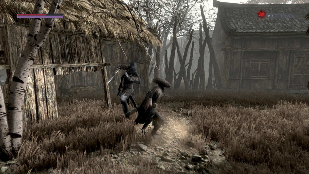 The player fights an assassin in a field between wooden huts. A typical gameplay moment from the game.