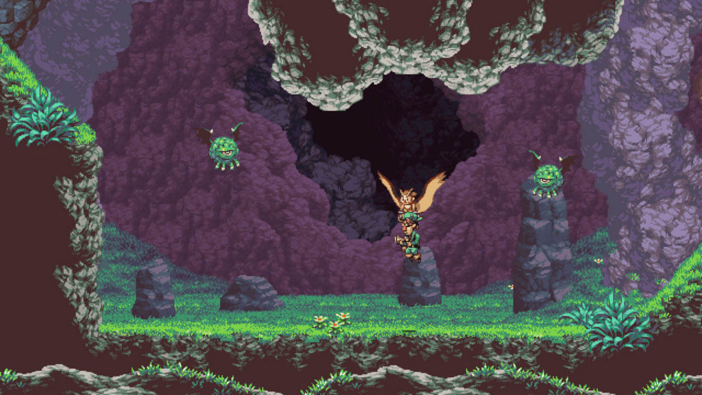In Owlboy you fly high above the clouds and let your friends fight for you, as this screenshot shows: In the center of the image we see Owlboy in a long shot. The protagonist looks like a brown owl and is flying straight over a 2D grassy landscape to the left with its wings spread. Directly below it, it carries a friend with it, who has a green outfit and a reddish nose. He carries an ancient-looking pistol in his hands. Although the grass on the horizontally running game platform looks lush green, the distant background consists of dark-red stony formations up to black areas. To the left and right of the player float two green alien-like round enemies with green legs and only one eye. From the ceiling, a dreary stony dark formation goes off.
