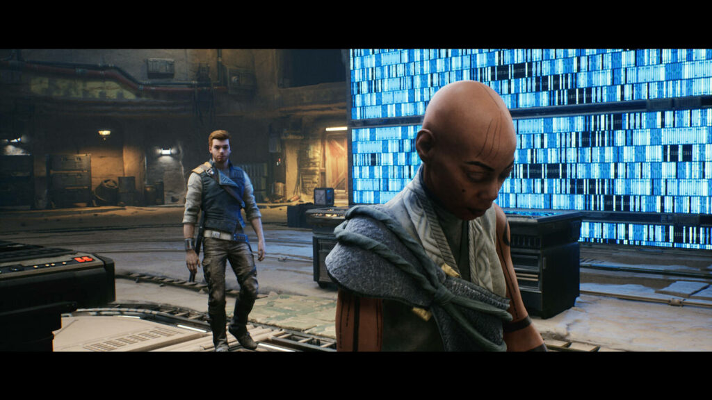 We see the protagonist Cal in Star Wars: Jedi Survivor standing in an old courtyard behind a character with brown skin.