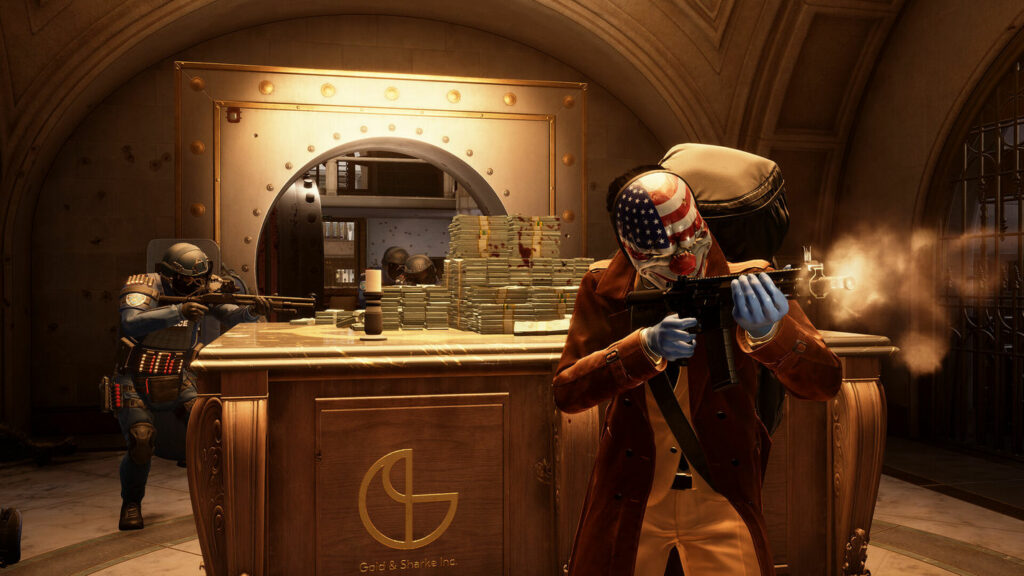 The masked player stands in a vault in front of numerous money banknotes. Behind him, we see Swat units entering the room.