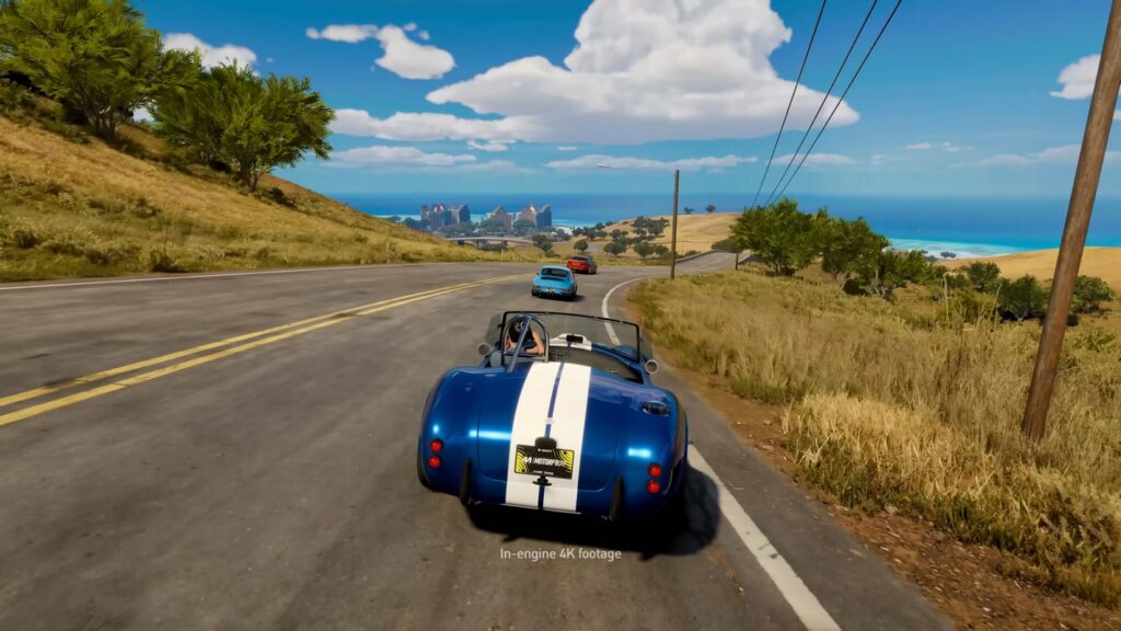 Experience rich colors in The Crew Motorfest from the release date. We see a blue car on a road under a bright blue sky.
