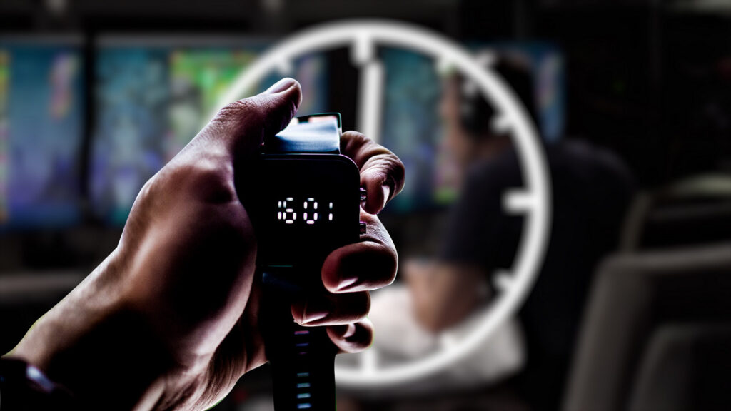 A speedrunning gamer and a stopwatch can be seen blurred in the background. In front of them, we see a stopwatch in focus.